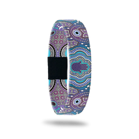 Single with purples and blues in a very detailed mosaic design. The center has a purple Hamsa. The inside is the same and reads Ray Of Light. This comes with a matching Hamsa charm to wear on the band. 