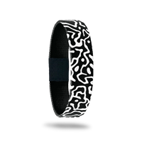 This is a reversible wristband. One one side is a black base with white swirls all over. The inside is the same design and reads Brave Enough To Be Yourself.. It is a single.