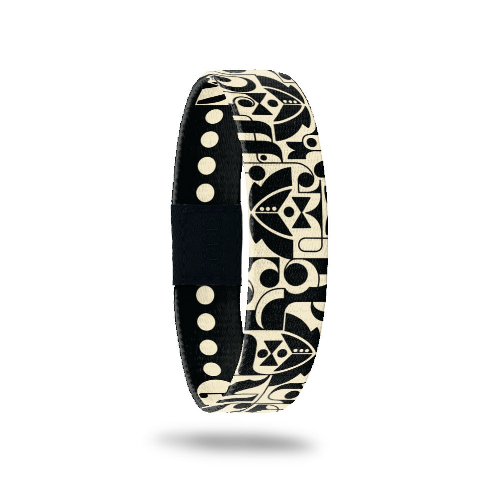 Wristband single with black base and geometric shapes that form tuxes, bowties and dress shirts. Inside reads Groom Crew. 