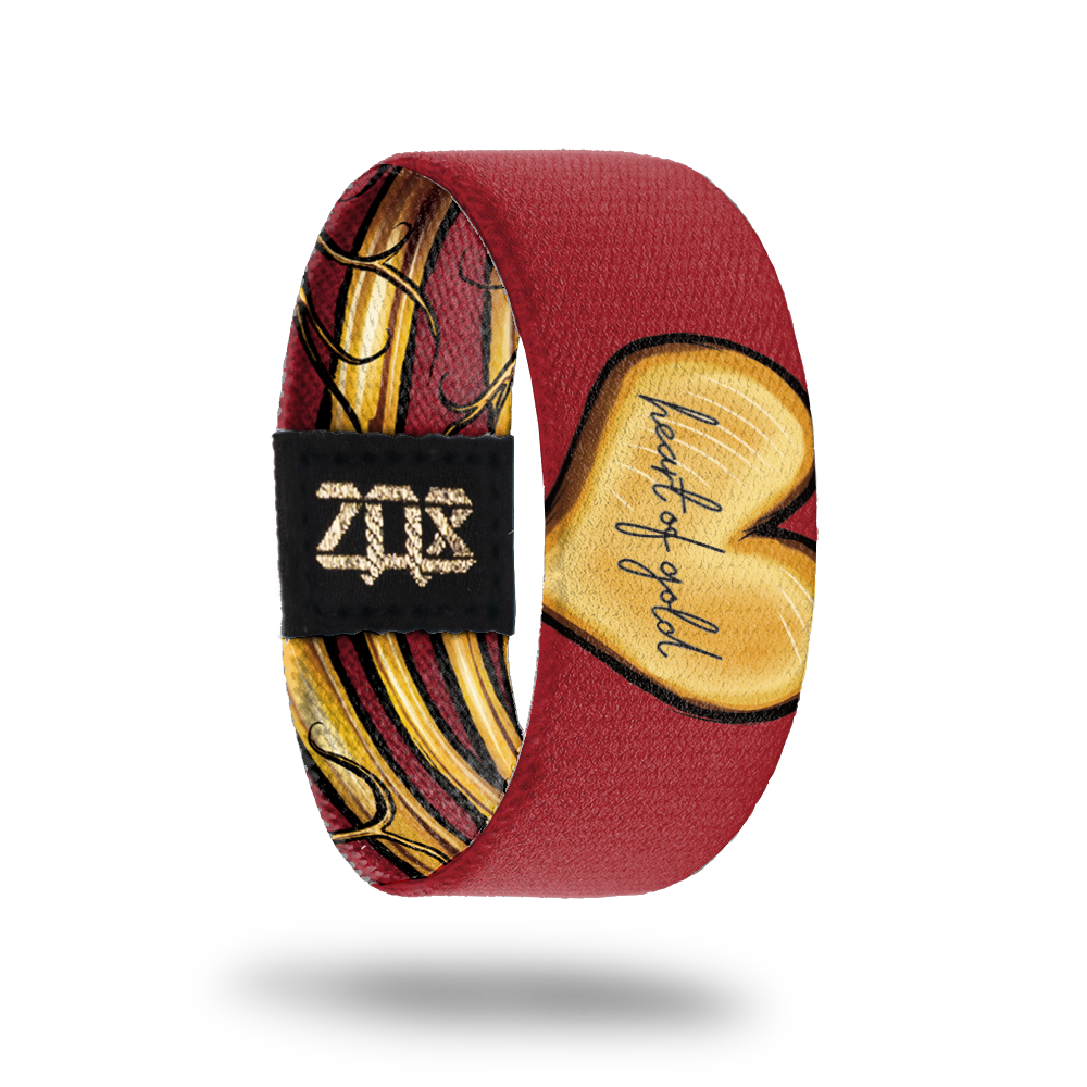 inside view of the heart of gold wristband. Dark red with gold heart shape, Heart of Gold text in the center. 