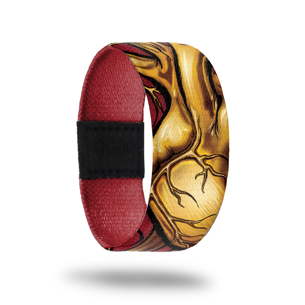 Dark red wristband with gold, lifelike heart drawing on outside.