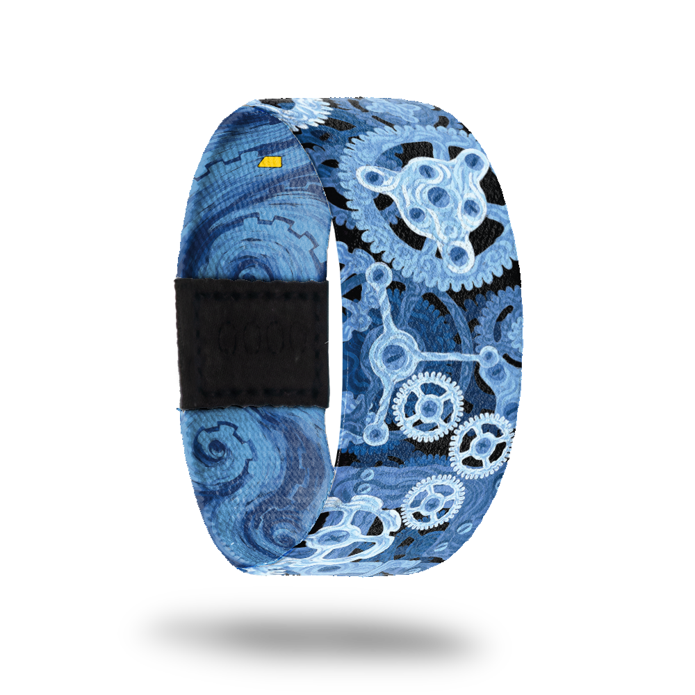 This is a reward item, do not purchase. The strap design is blue clock gears working together. The inside is blue swirls and reads Make It Work. This comes with a matching lapel pin. 