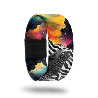 Outside: Half is a cat in black and white with a zebra print in the background. Other half is brightly colored sky and clouds of all colors. Inside is the same cloud design and reads "Never Stop Dreaming".