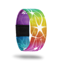Wristband strap with a very bright and rainbow color-ed outside. All colors blend together and have a white swirl/star design on top. The inside is the same and reads Normal Is Boring. 