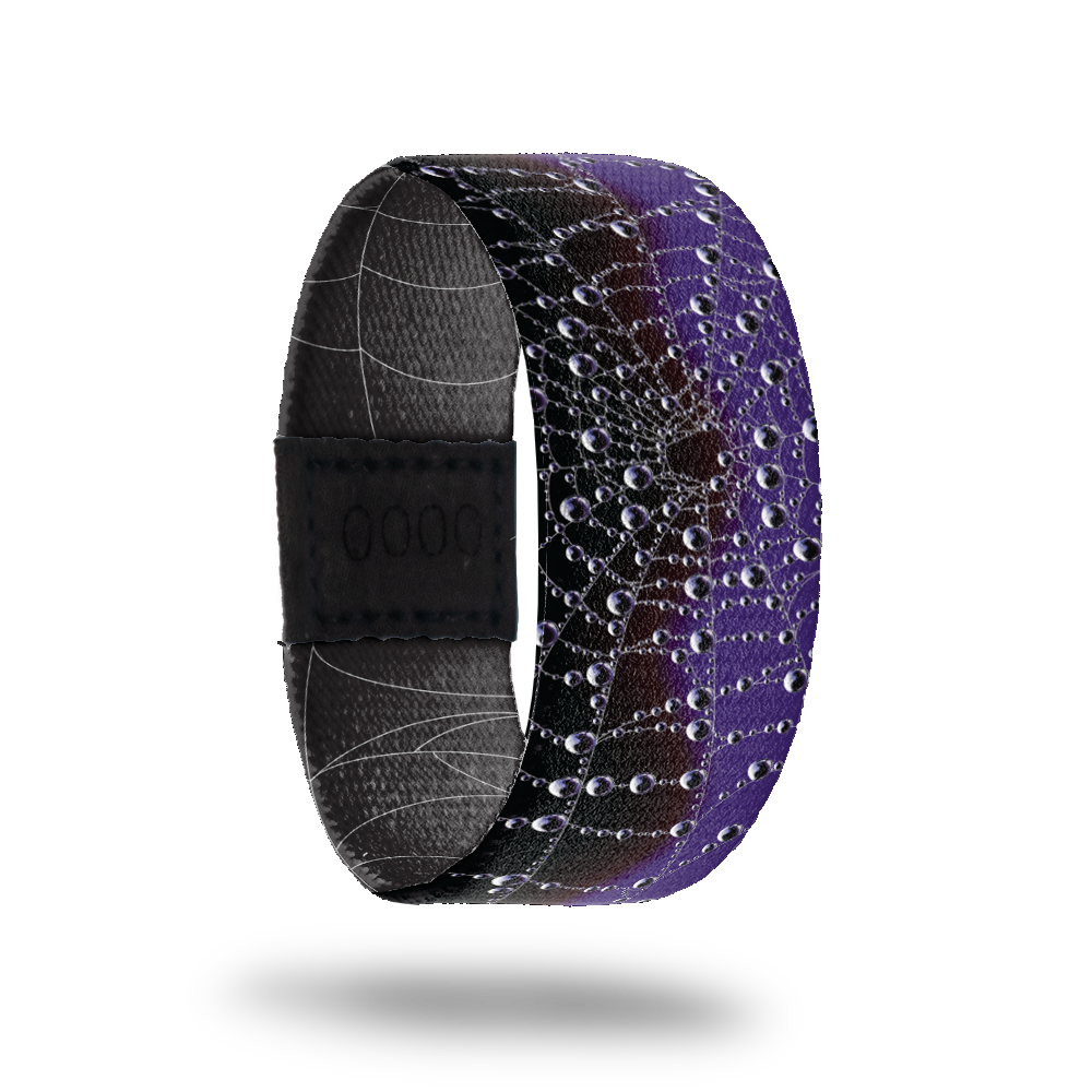 Wristband strap is black and purple with a spider web across the whole band. Comes with a matching purple and black spider lapel pin an collector's box. 