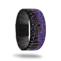 Wristband strap is black and purple with a spider web across the whole band. Comes with a matching purple and black spider lapel pin an collector's box. 