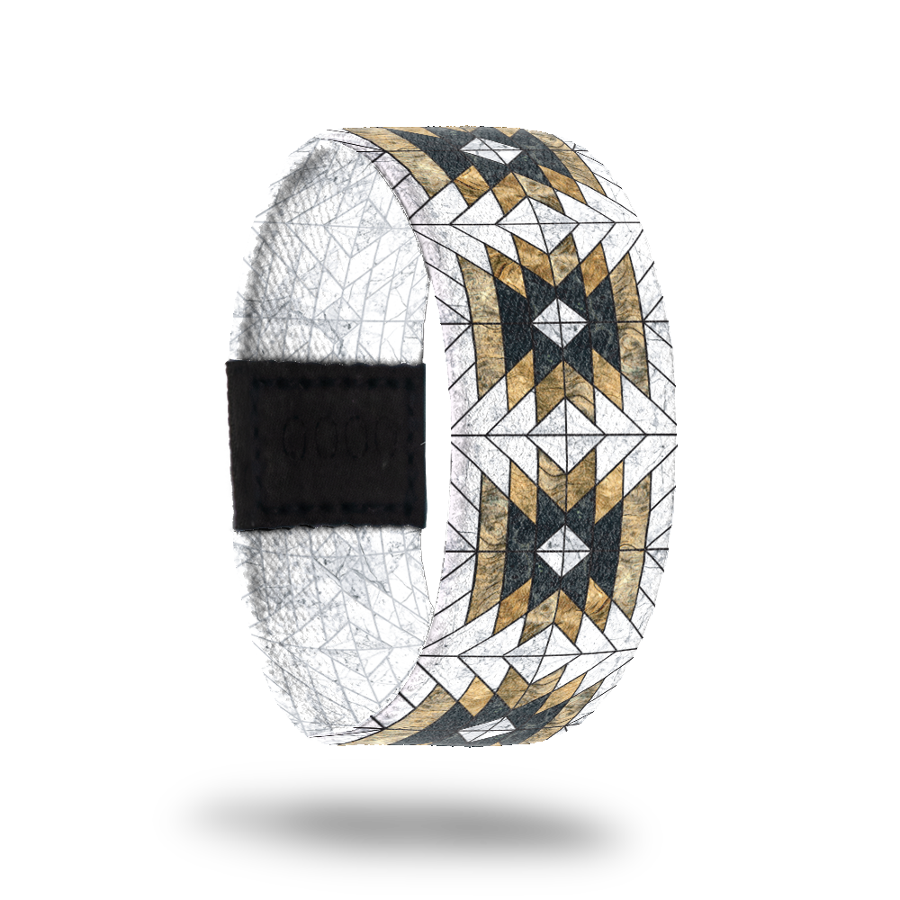 Outside design of Love Who You Are. Geometric repeating pattern with the colors white, yellow-gold, and black.