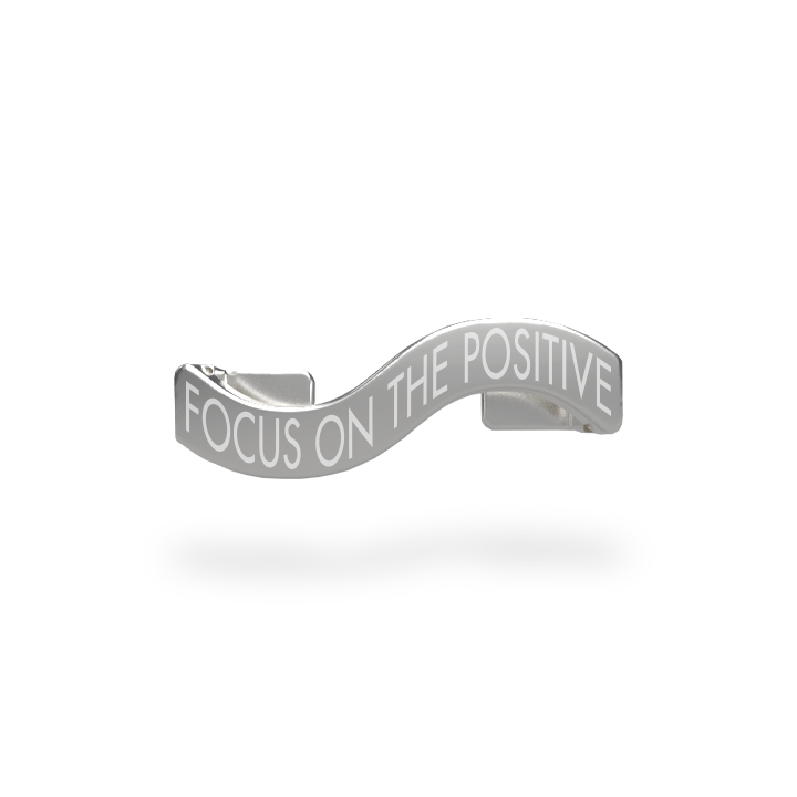 This is a charm that fits ZOX single wristbands, lanyards and hoodie strings only. It is made from stainless steel and is silver in color. The words FOCUS ON THE POSITIVE are etched in the metal.