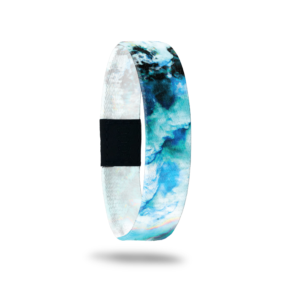 Wristband with a blue, teal, black and white marble design. Inside reads Focus On The Positive. 