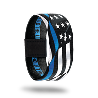 Outside Design of Hold The Line. wavy black and white United States flag with a line of blue for one bottom stripe of the flag