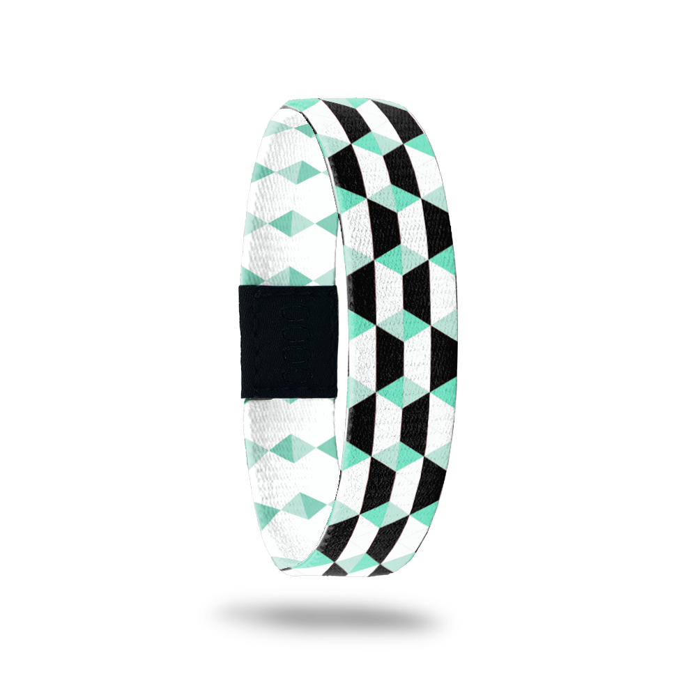 Black, white and mint colored parallelograms all over the design. Inside is the same but in mint and white and says Just Breathe. 