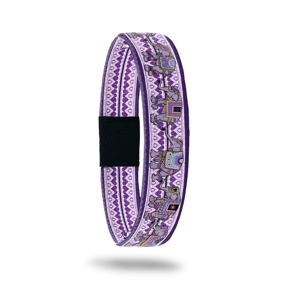 Product photo of Love Remembers showing the outside design. It is mainly purple with elephants on top of the geometric background pattern. It was created to help fight Alzheimer's 