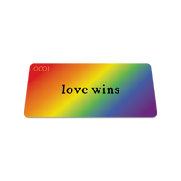 Front collector's card image of Love Wins: rainbow gradient with black text ‘Love Wins’ on strap