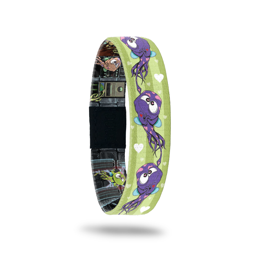 Product photo of the outside of 2021 - Day 10 - Leon Lovestruck: green background with two lighter shaded green stripes and repeating blue and white hearts and repeating purple monsters with pink hearts all over and one red heart and blue wings