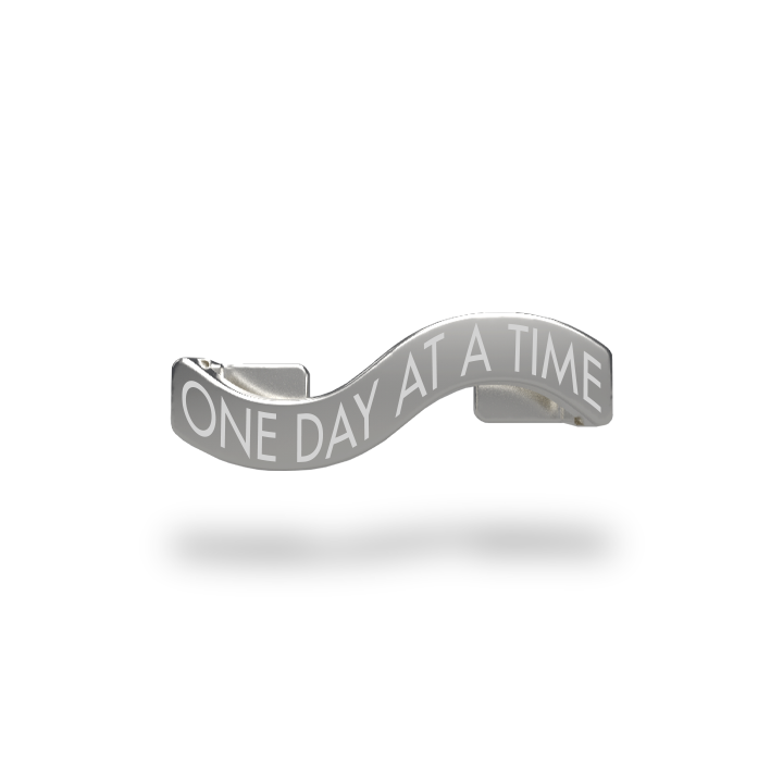 This is a charm that fits ZOX single wristbands, lanyards and hoodie strings only. It is made from stainless steel and is silver in color. The words ONE DAY AT A TIME are etched in the metal.