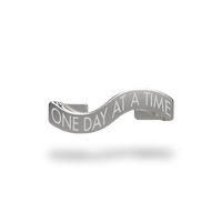This is a charm that fits ZOX single wristbands, lanyards and hoodie strings only. It is made from stainless steel and is silver in color. The words ONE DAY AT A TIME are etched in the metal.