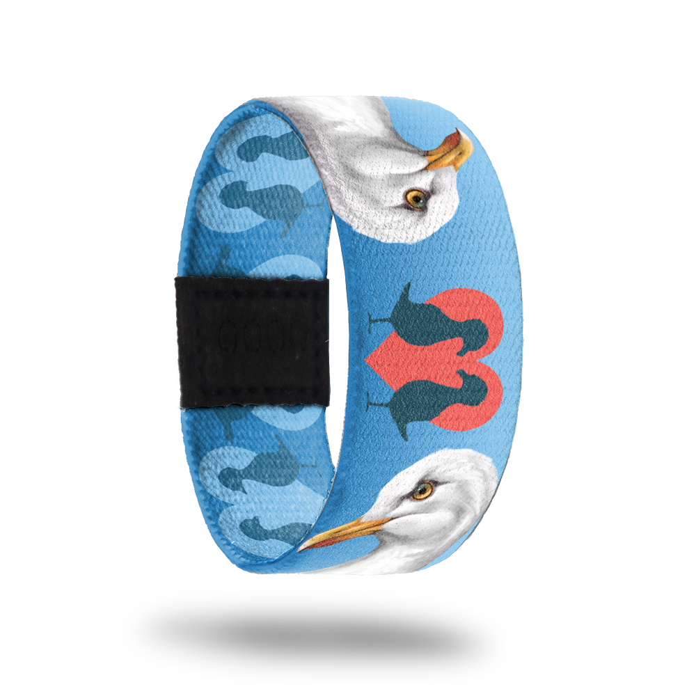 Still image of outside design for the dove. Light blue background with the dove being white with an orange beak