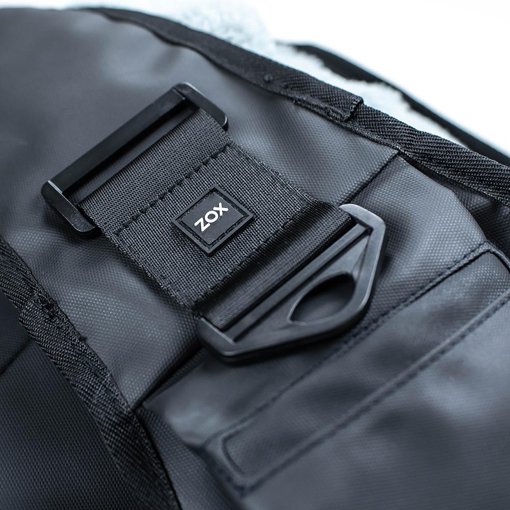 Close up detailed product photo showing where you can attach a closure strap to as well as the phone pocket