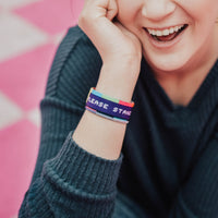Lifestyle image of Please Stand By on wrist of smiling model