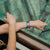 Lifestyle image of arms resting on railing with In This Together on wrist