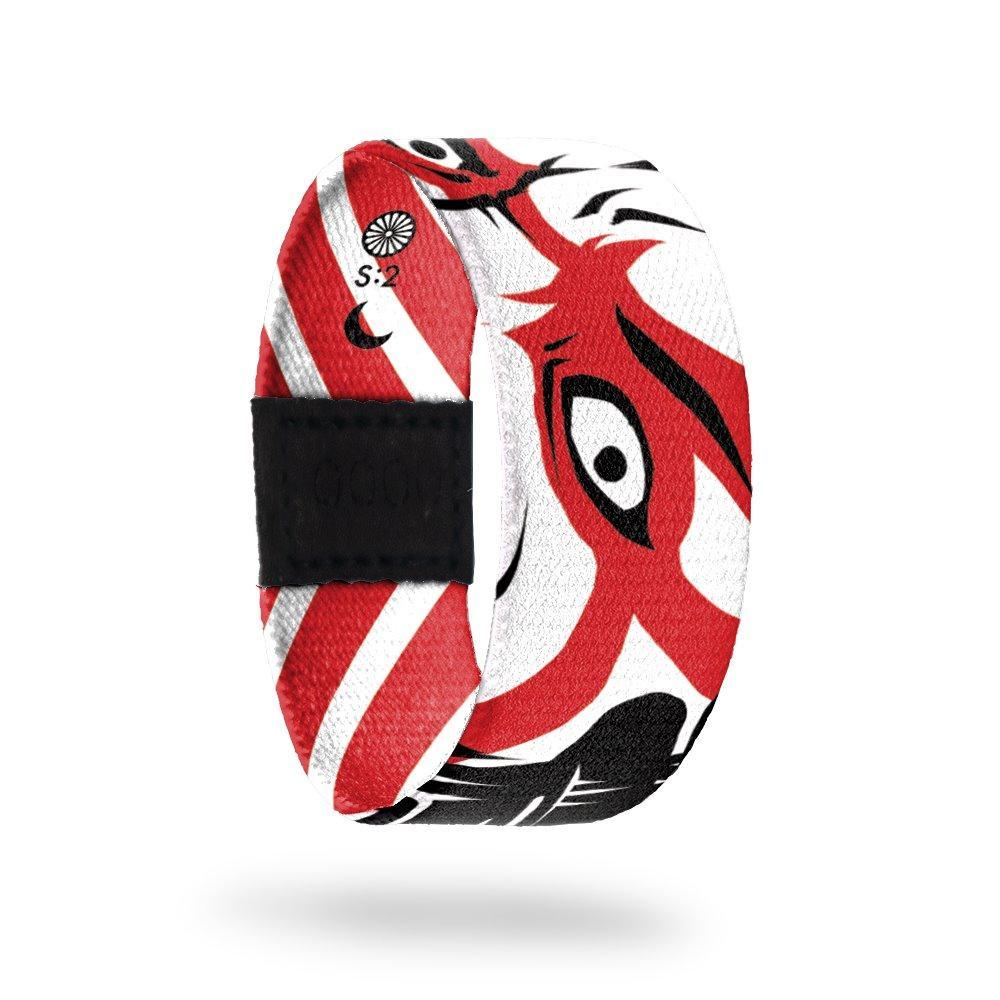 This is a reward item, do not purchase. The strap is black and white stripes with the eye of a ninja in he center. The inside says Kabuki. Comes with a matching pin. 