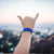 Lifestyle image of hand giving the hang loose sign with Life Saver on wrist 