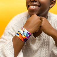 Studio Image close up of 2 Fire & Ice on 1 wrist with model smiling and has knuckles resting against each other