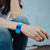Lifestyle close up image of 1 Go With The Flow on wrist resting on bend legs