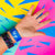 Studio Image of 2 Let Go on a wrist in front of a colorful background
