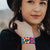 Lifestyle close up image of smiling model and My Best Self on their wrist