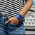 Lifestyle image close up of model's hand in pocket with 2 Nightfall on wrist