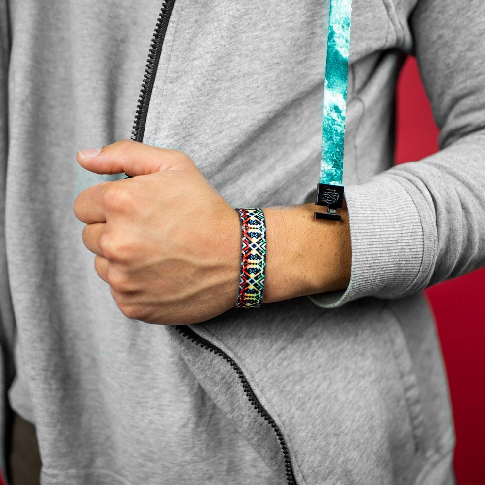 Studio photo close up on the wrist of a guy wearing a ZOX hoodie showing the outside design of never surrender