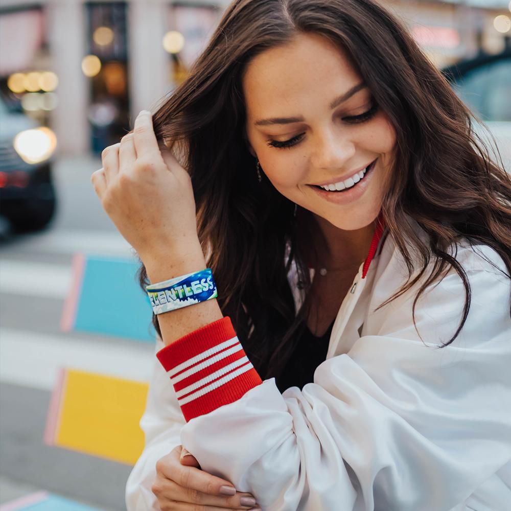 Lifestyle image of a Relentless on wrist of smiling model