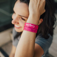 Lifestyle image close up of someone smiling with 2 Strength and Beauty on their wrist 