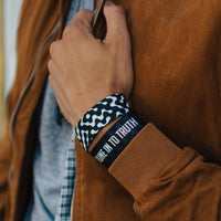 Lifestyle close up image of model's wrist wearing 2 Tune In To Truth straps