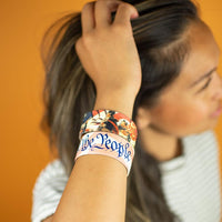 Studio image close up of 2 We The People on model's wrist