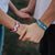 Models holding hands wearing one blue and one pink You & Me