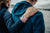 Lifestyle image of hand resting on someone's shoulder wearing Hold On